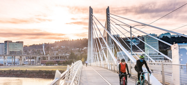People riding bicycles and talking about moving from Dallas–Fort Worth metroplex to Portland with toddlers.
