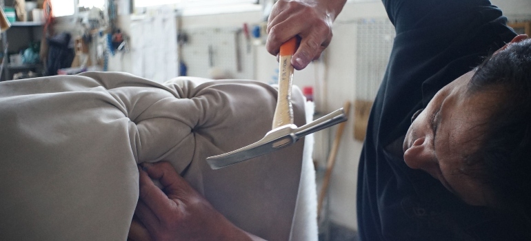 man repairing sofa