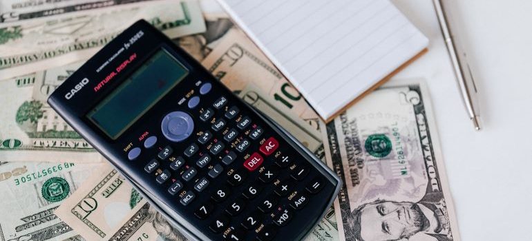 Calculator and a stack of dollars