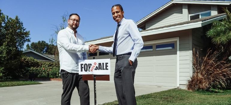 A person consulting with a realtor before investing in real estate in Houston